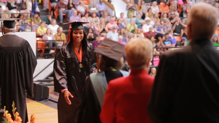 graduate crosses the stage