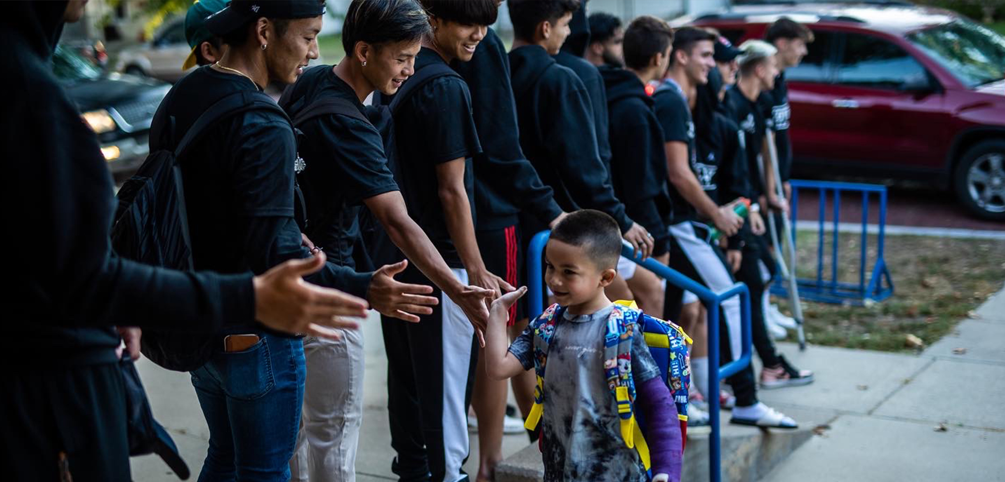 cowley college students greeting grade school children