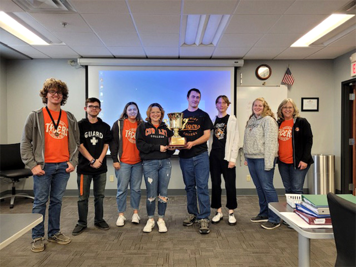 Cowley Collegiate Quiz Bowl team holds trophy