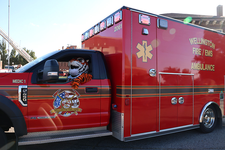 tank the tiger mascot driving a fire truck