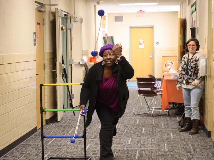 a woman playing a yard game