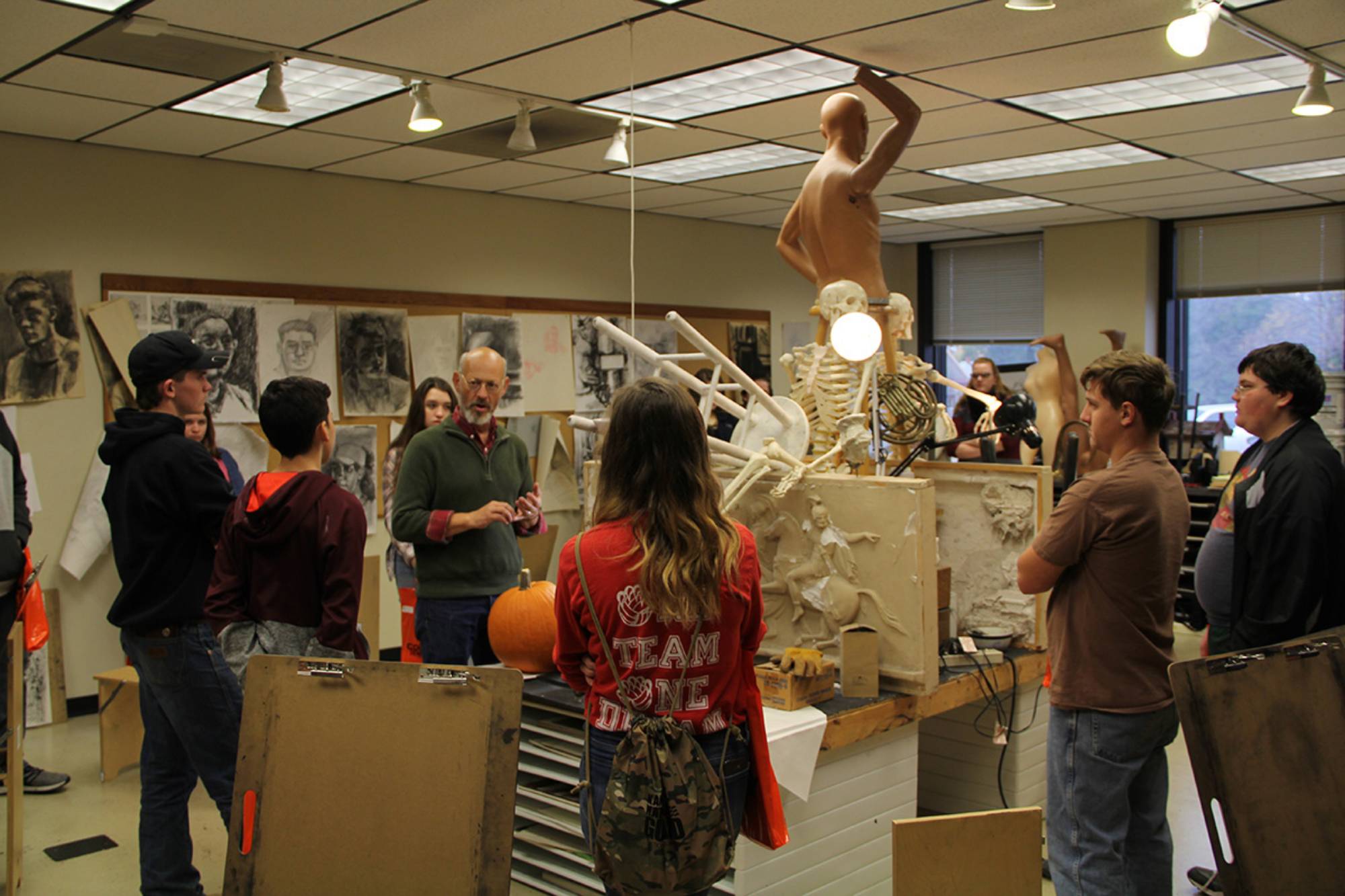 instructor with students in art classroom