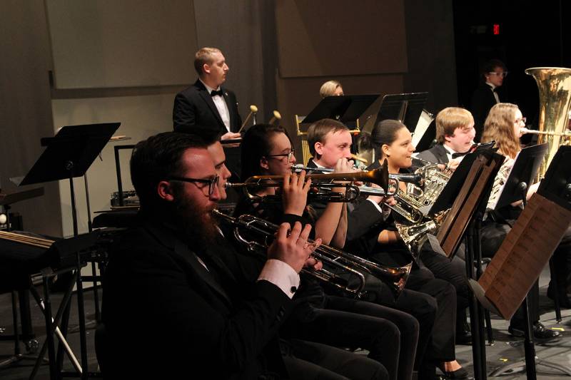 Students playing instruments on stage