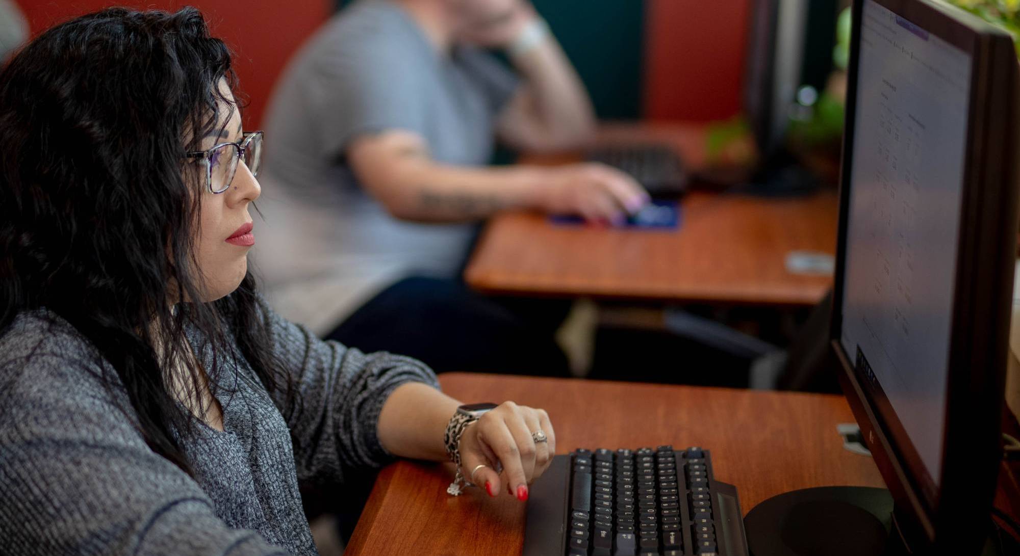 woman and man looking at computer screens