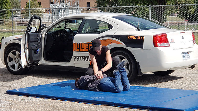 student practicing handcuffing