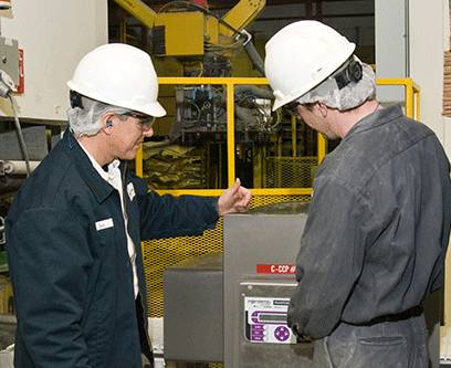 two milling techs by a machine