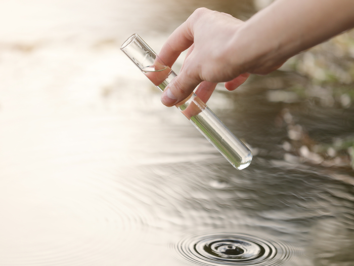 environmental scientist taking water sample