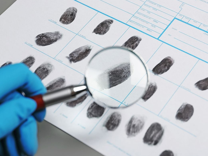 technician examining finger prints