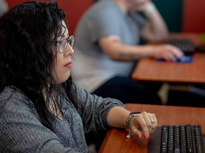 woman and man looking at computer screens