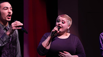 Two students singing at a concert