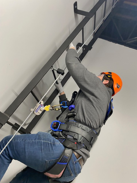 wind energy student a the top of a climb test